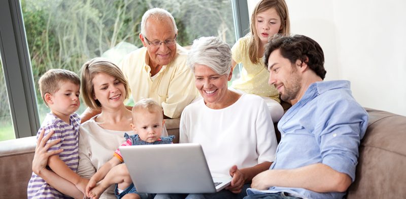family enjoying streaming show, watching on a laptop, with the help of wireless home internet access