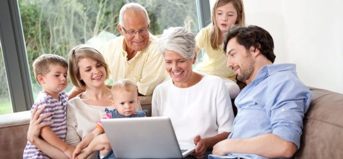 family enjoying streaming show, watching on a laptop, with the help of wireless home internet access
